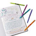 A notebook with writing and colorful Paper Mate InkJoy pens.