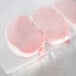 VacPak-It 15" x 50' roll of full mesh external vacuum packaging bags with pork chops on a plastic sheet.