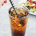 A Libbey stainless steel iced tea spoon in a glass of iced tea.