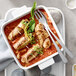 Villeroy & Boch white porcelain square serving dish with meat and vegetables in it, with a fork.