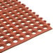 A close-up of a red rubber Cactus Mat with holes in it.