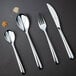 A Chef & Sommelier stainless steel oyster/cocktail fork on a black surface.
