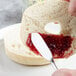 A person spreading jam on a piece of bread with a Master's Gauge Pebblestone butter spreader.