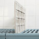 A white MetroMax i plastic shelf divider.