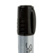 A close up of a Sharpie Magnum black marker with a silver cap.