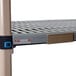 A metal shelf with a blue and white MetroMax Q label holder on it.