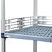 A white metal shelf ledge with black metal bars.