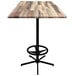 A wooden bar table with a metal foot rest base.