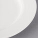 A close-up of a Villeroy & Boch white porcelain plate with a white rim.