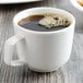 A Villeroy & Boch white porcelain cup of coffee on a table.