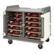 A large gray Cambro meal delivery cart with many trays on shelves.