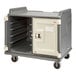 A granite gray Cambro meal delivery cart with a door open.