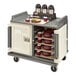 A Cambro meal delivery cart with trays and drinks on it.