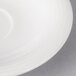 A close-up of a Villeroy & Boch white porcelain saucer with a thin black rim.