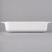 A white rectangular baking dish with handles.