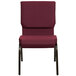 A burgundy church chair with a gold vein frame.