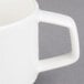 A Villeroy & Boch white porcelain stackable cup with a handle.