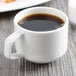 A Villeroy & Boch white porcelain cup of coffee on a table.