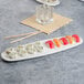 A Villeroy & Boch white porcelain oval plate with sushi and chopsticks on it.