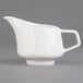 A white Villeroy & Boch porcelain creamer with a handle.