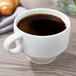 A Villeroy & Boch white porcelain cup filled with coffee on a table.