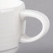 A close-up of a Villeroy & Boch white porcelain stackable cup with a handle.
