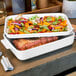 A white Villeroy & Boch rectangle baking dish with food in it.