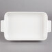 A white rectangular baking dish with handles.