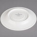 A white Villeroy & Boch porcelain saucer with a white rim and black text.