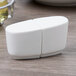 A Villeroy & Boch white porcelain salt and pepper shaker set on a table.