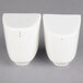 Two white ceramic Villeroy & Boch salt and pepper shakers.