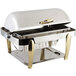 A Bon Chef stainless steel roll top chafer with brass accents and a vented lid.