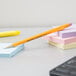 A yellow Paper Mate Sharpwriter mechanical pencil on sticky notes.