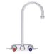 A silver Fisher wall mount faucet with 4" centers, swivel gooseneck nozzle, and red and blue lever handles.