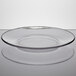 An Anchor Hocking clear glass plate with a rim on a white surface.