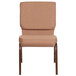 A brown church chair with a brown cushion and metal legs.
