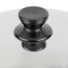 A black knob on a stainless steel pot lid.