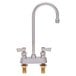 A silver Fisher deck-mounted faucet with swivel gooseneck spout and lever handles.