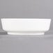 A white Villeroy & Boch porcelain salad bowl on a gray surface.