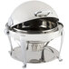 A Bon Chef stainless steel round chafer with chrome accents and a roll top lid on a table.