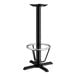 A Lancaster Table & Seating black cast iron bar height table base with a foot ring.