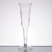 A clear plastic Fineline Flairware champagne flute on a table.