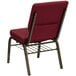 A Flash Furniture burgundy church chair with metal legs.