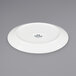 A white Tuxton oval coupe china platter with a black rim.