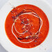 A white plate with red bell peppers on a white background.