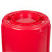 A red Rubbermaid BRUTE round plastic container with a lid.