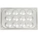 A white tray with circles for eggs in it.