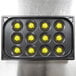 A black Vollrath egg poacher pan with yellow eggs in it.
