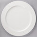 A white porcelain round platter with a pattern on it.