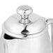 A Vollrath stainless steel creamer with a lid.
